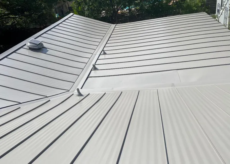 Solar attic fan installed on a metal roof for Roof Ventilation in Walled Lake